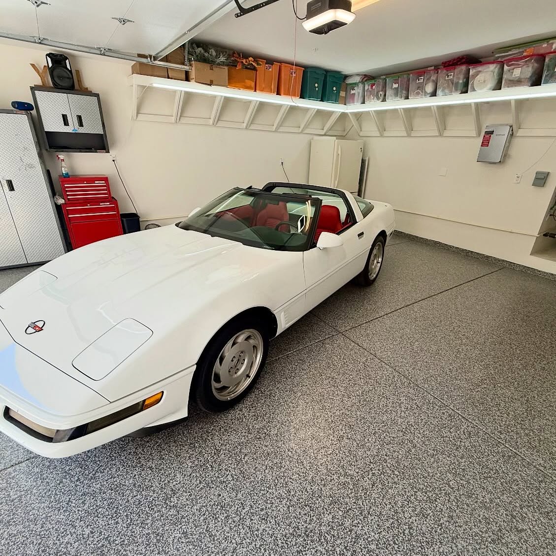 Finished decorative chip epoxy garage floor with a car parked inside
